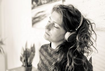 woman listening to music on cordless headphones